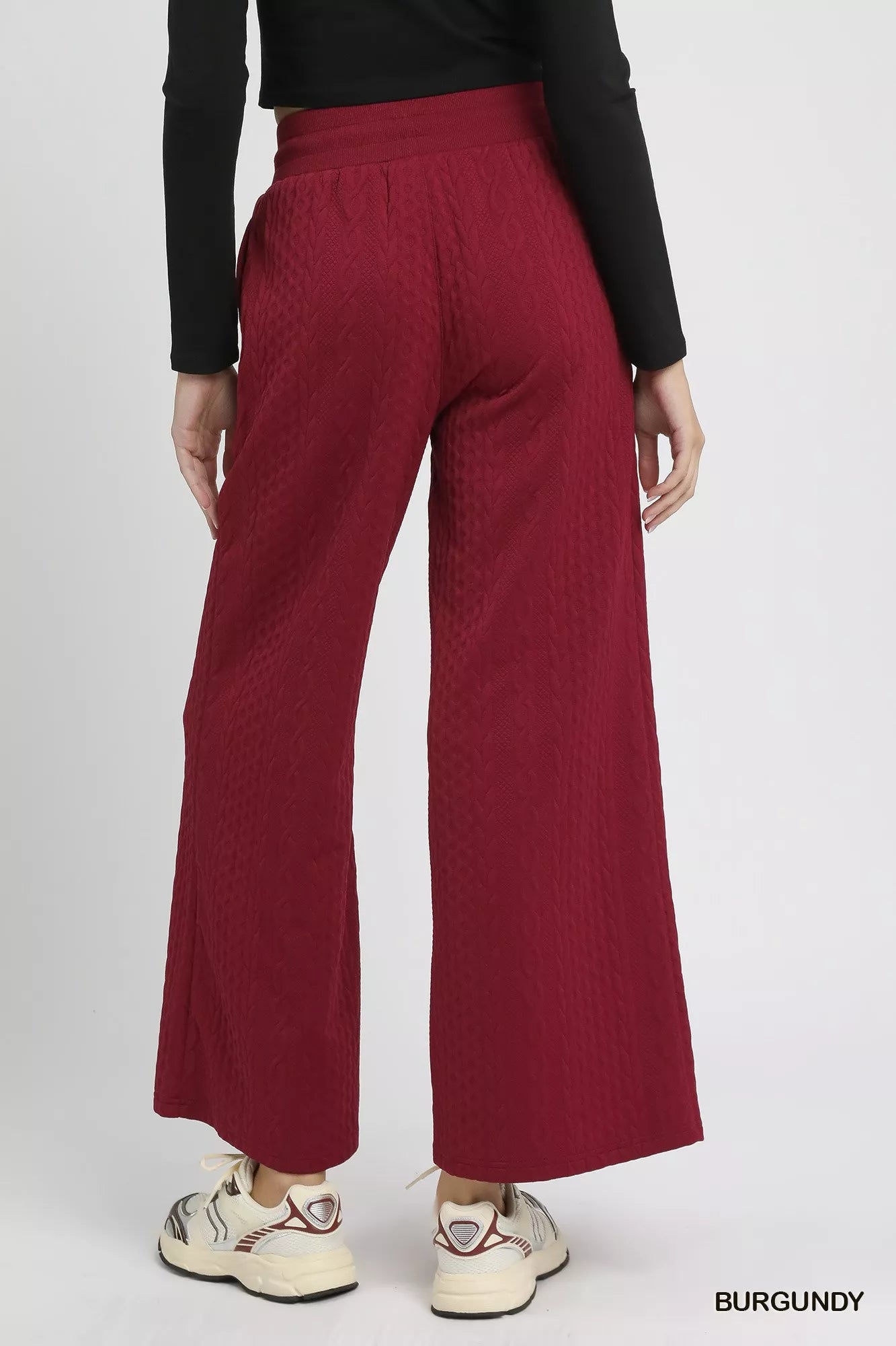 Burgundy cable knit textured wide leg pants with drawstring waist, rear view.