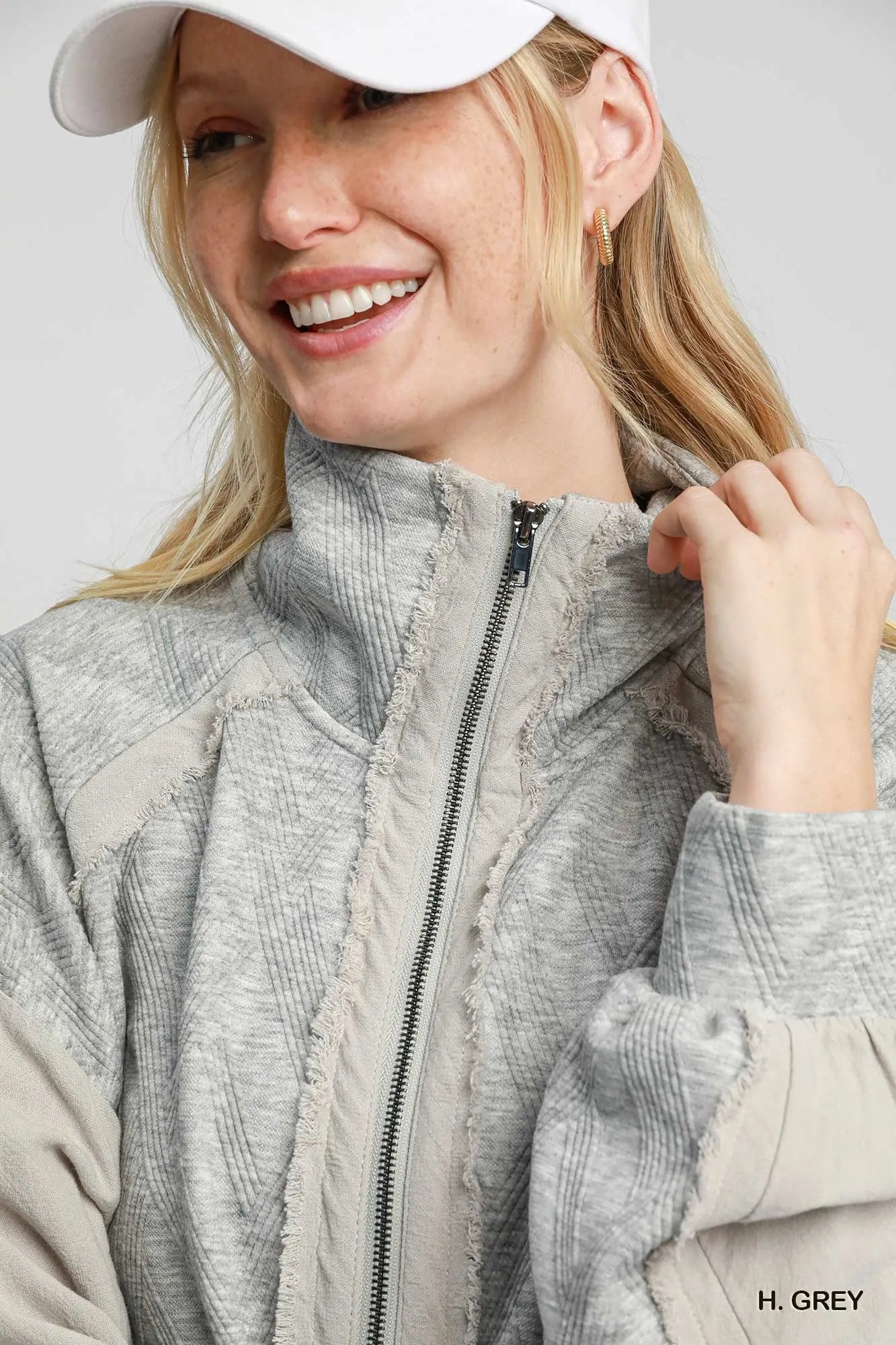 Woman modeling a gray two-way jacquard zip-up linen jacket with fringed edges.