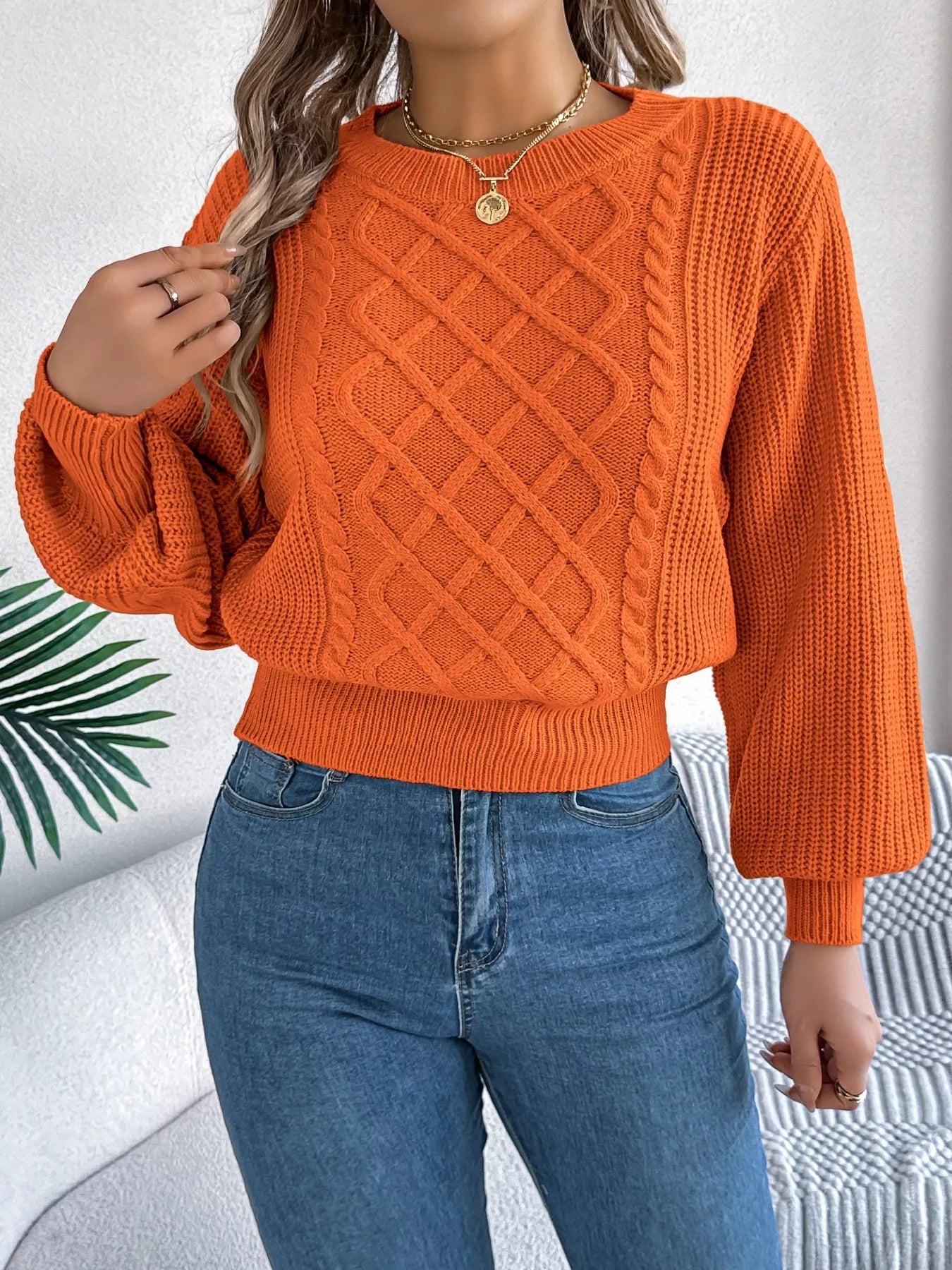 Long sleeve acrylic sweater with cable knit diamond pattern in neutral color