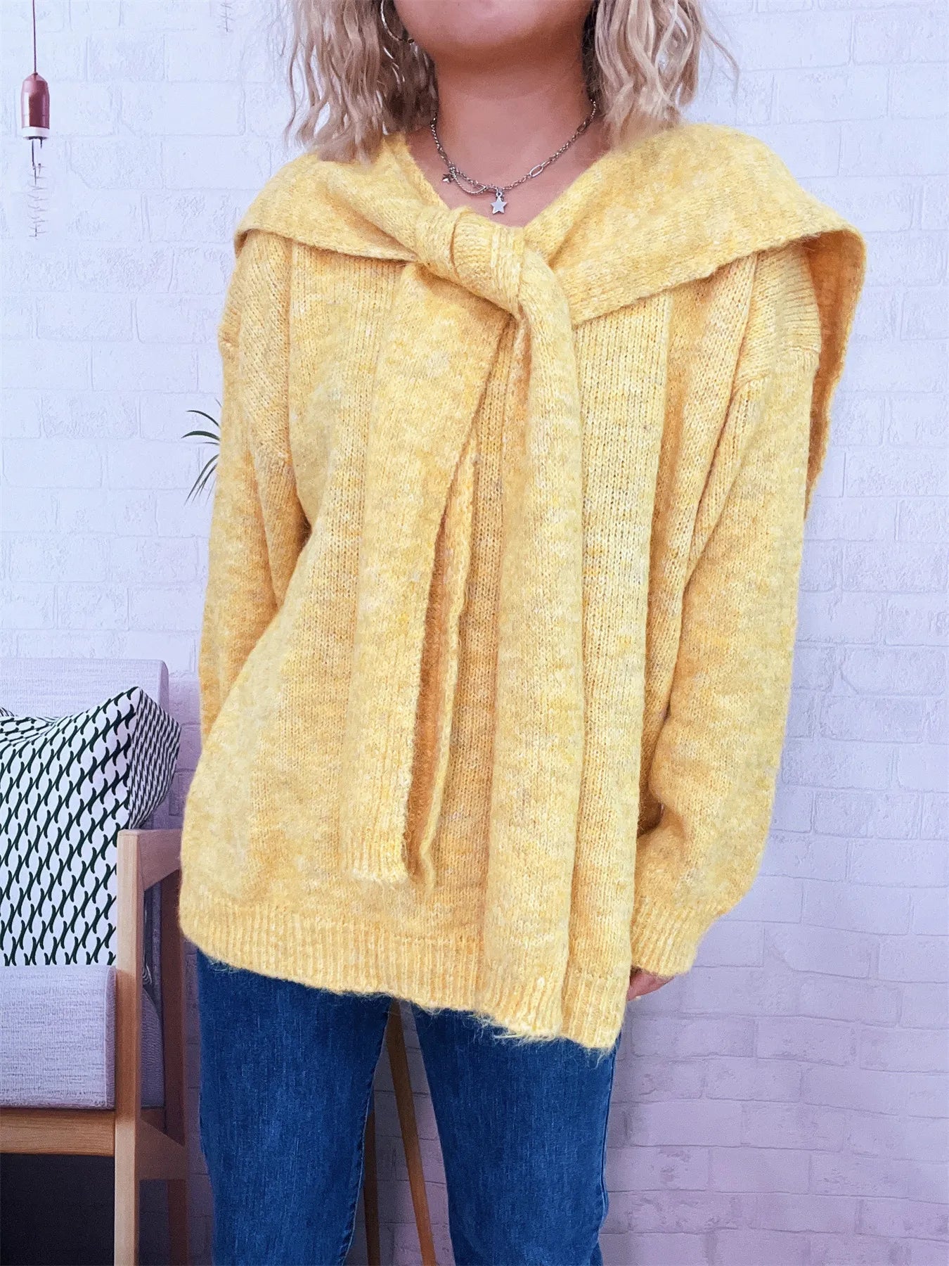 Ribbed hem V-neck sweater with shawl, slightly stretchy, made of 100% polyester.
