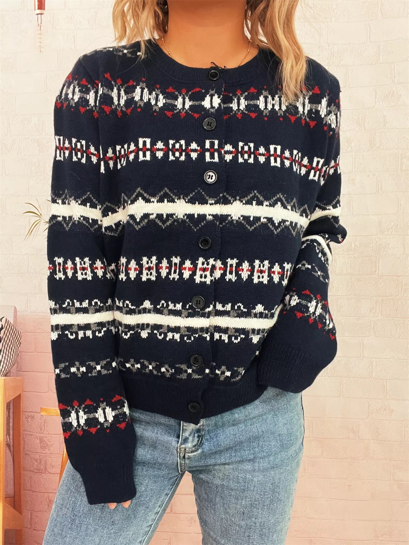 A vintage pattern button-down cardigan made of 100% polyester with a slightly stretchy fit.