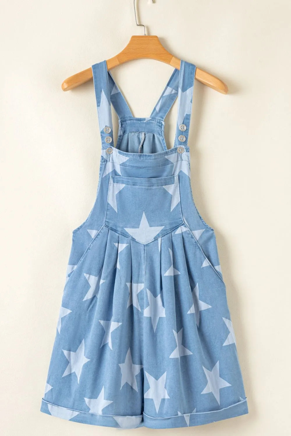 Denim overalls with a star print, square neck, and pocketed design in a cotton blend.