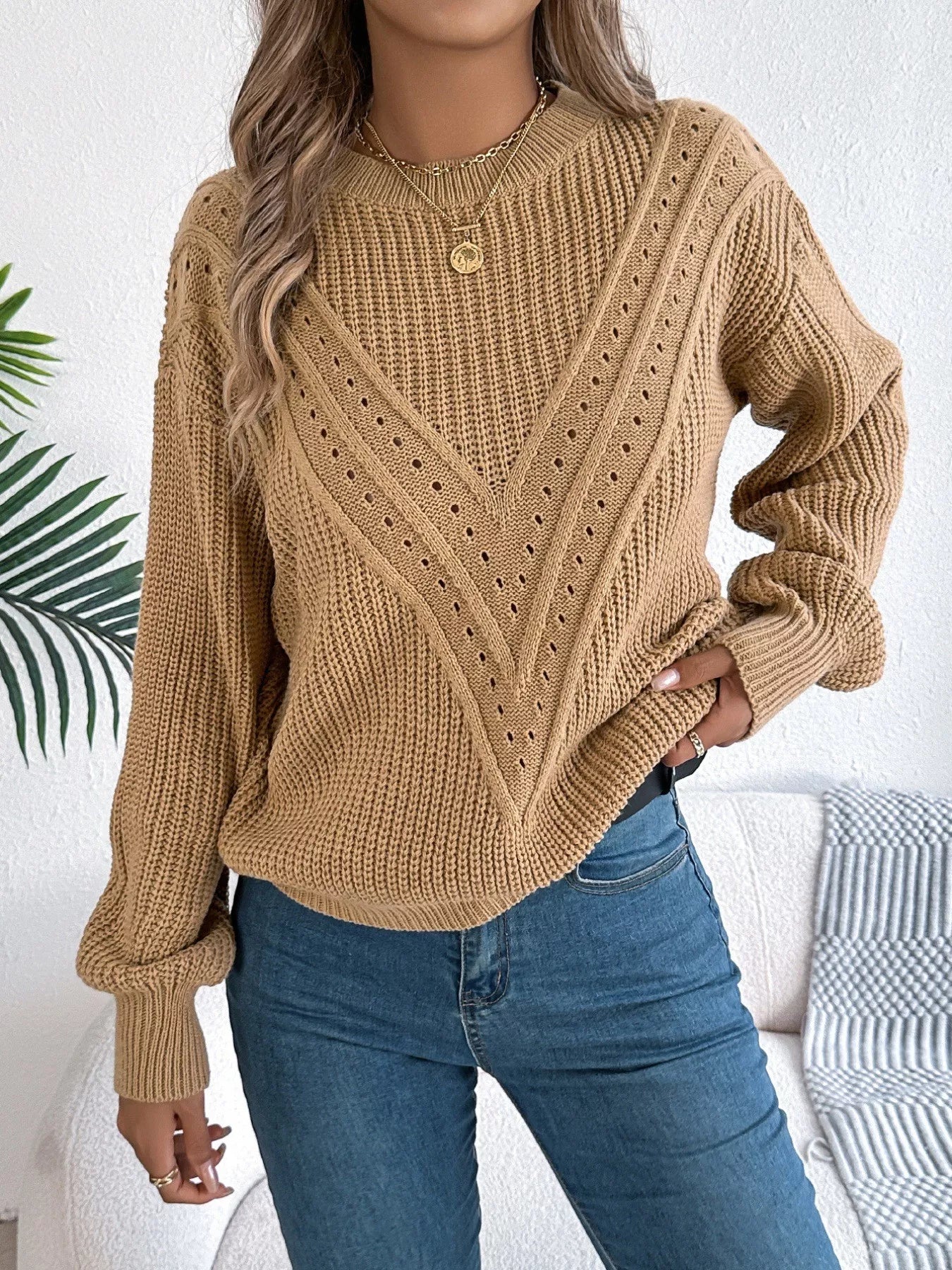 Lightweight openwork acrylic sweater with a round neck and slightly stretchy fit.