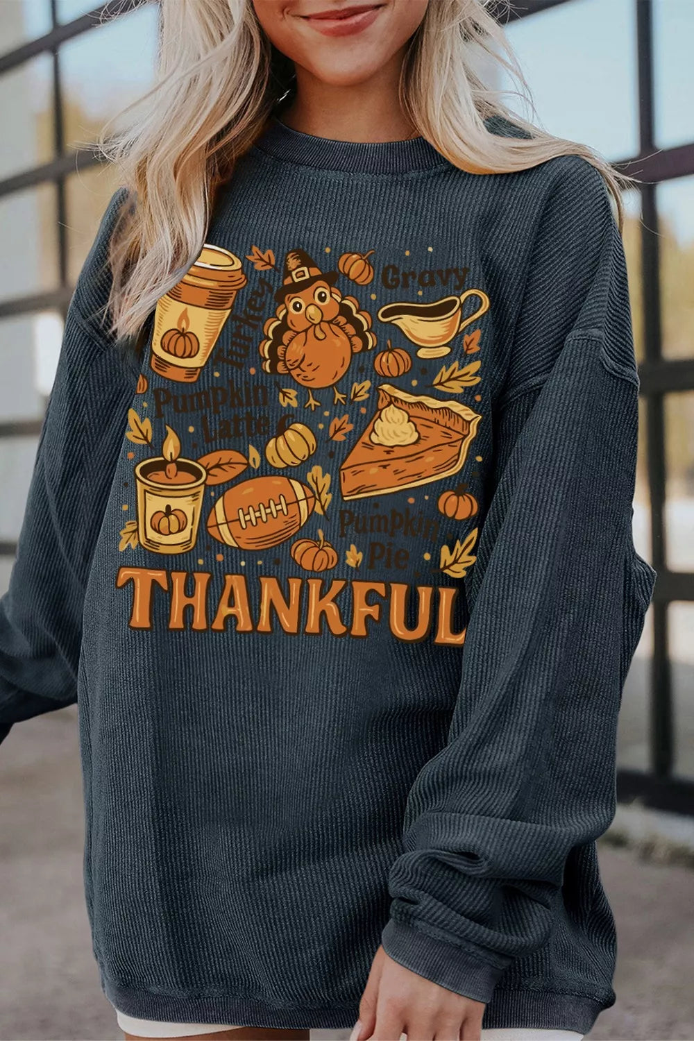 A long sleeve sweatshirt with a "Thankful Thanksgiving" graphic design.