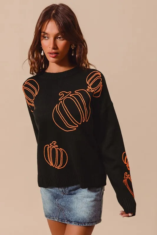 Black knit sweater with orange embroidered pumpkins, crew neck, long sleeves.