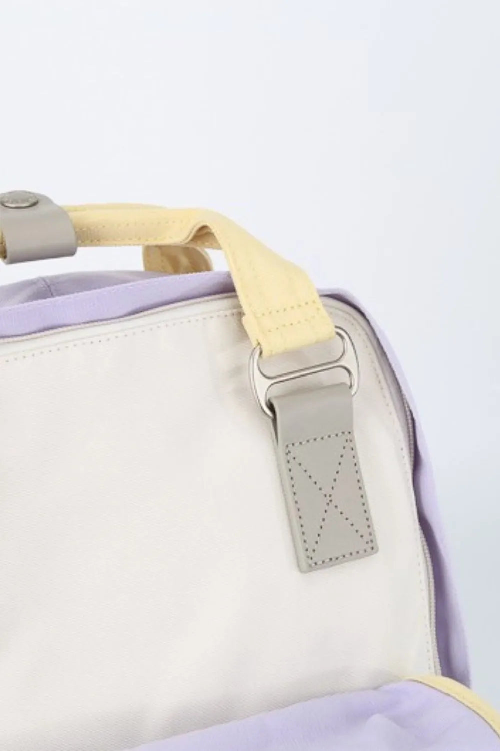 Himawari water-resistant nylon backpack in purple, yellow, and white with contrast straps.
