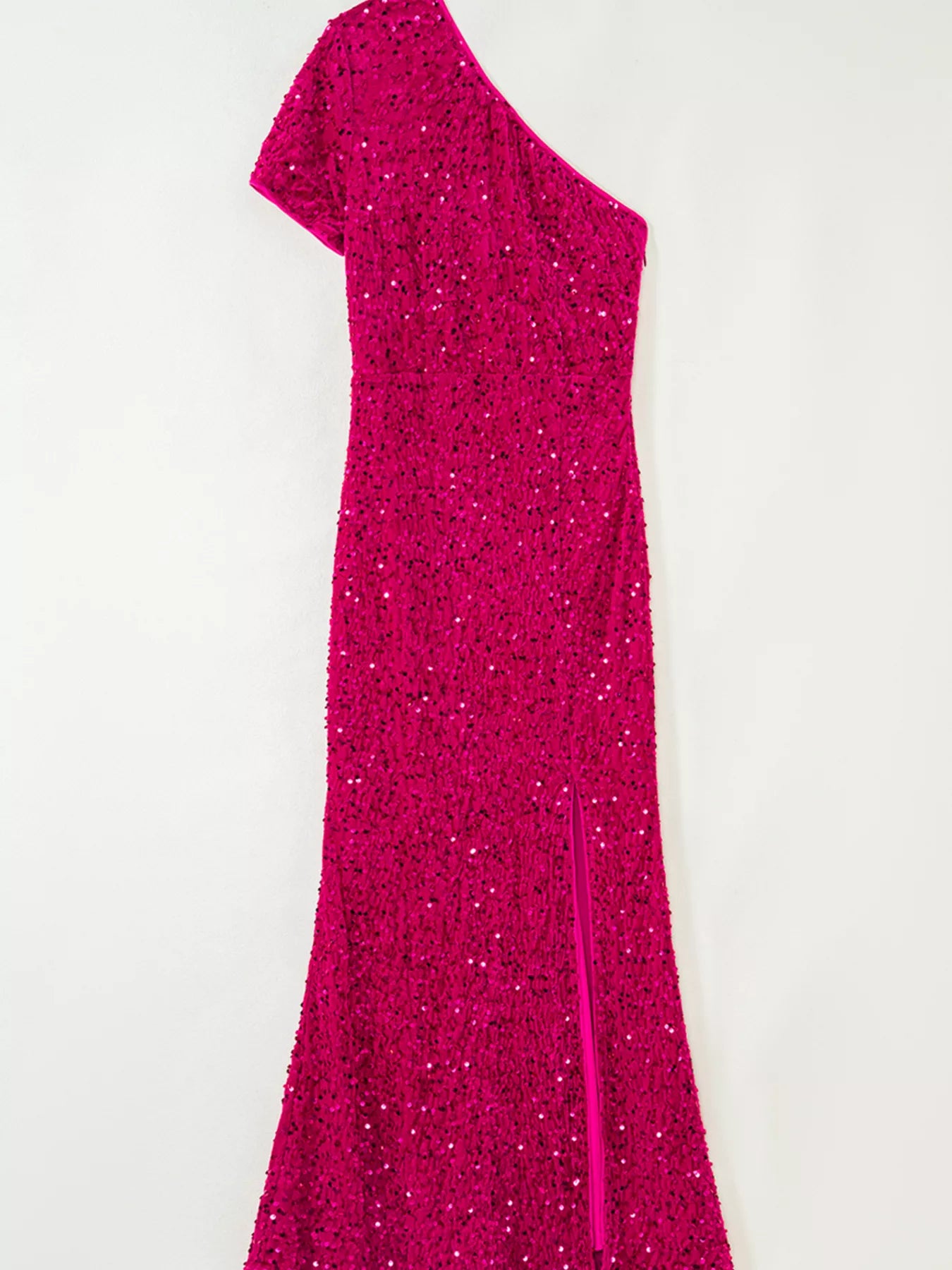 One-shoulder sequin dress in cotton spandex blend with a high slit and elegant silhouette.