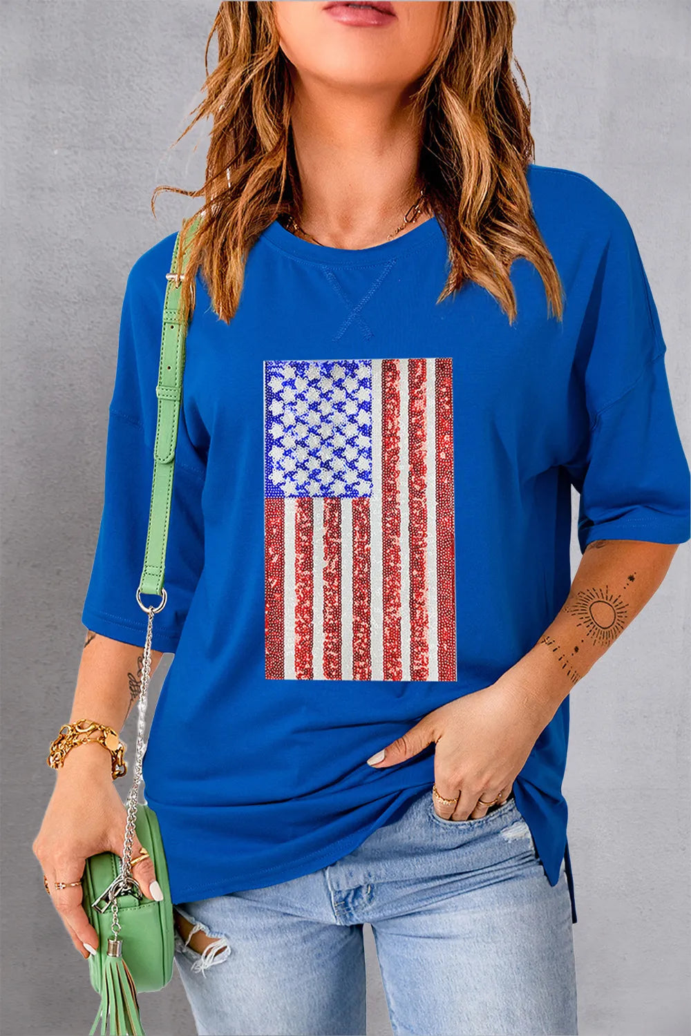 White t-shirt with US flag design, round neck, and half sleeves made from cotton blend.