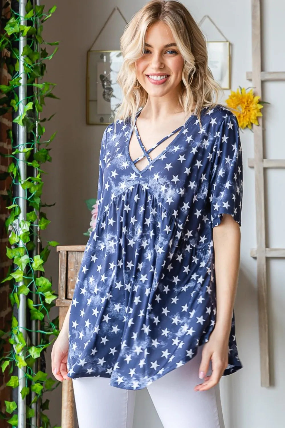 Short sleeve babydoll top with star print and crisscross detail in a relaxed fit