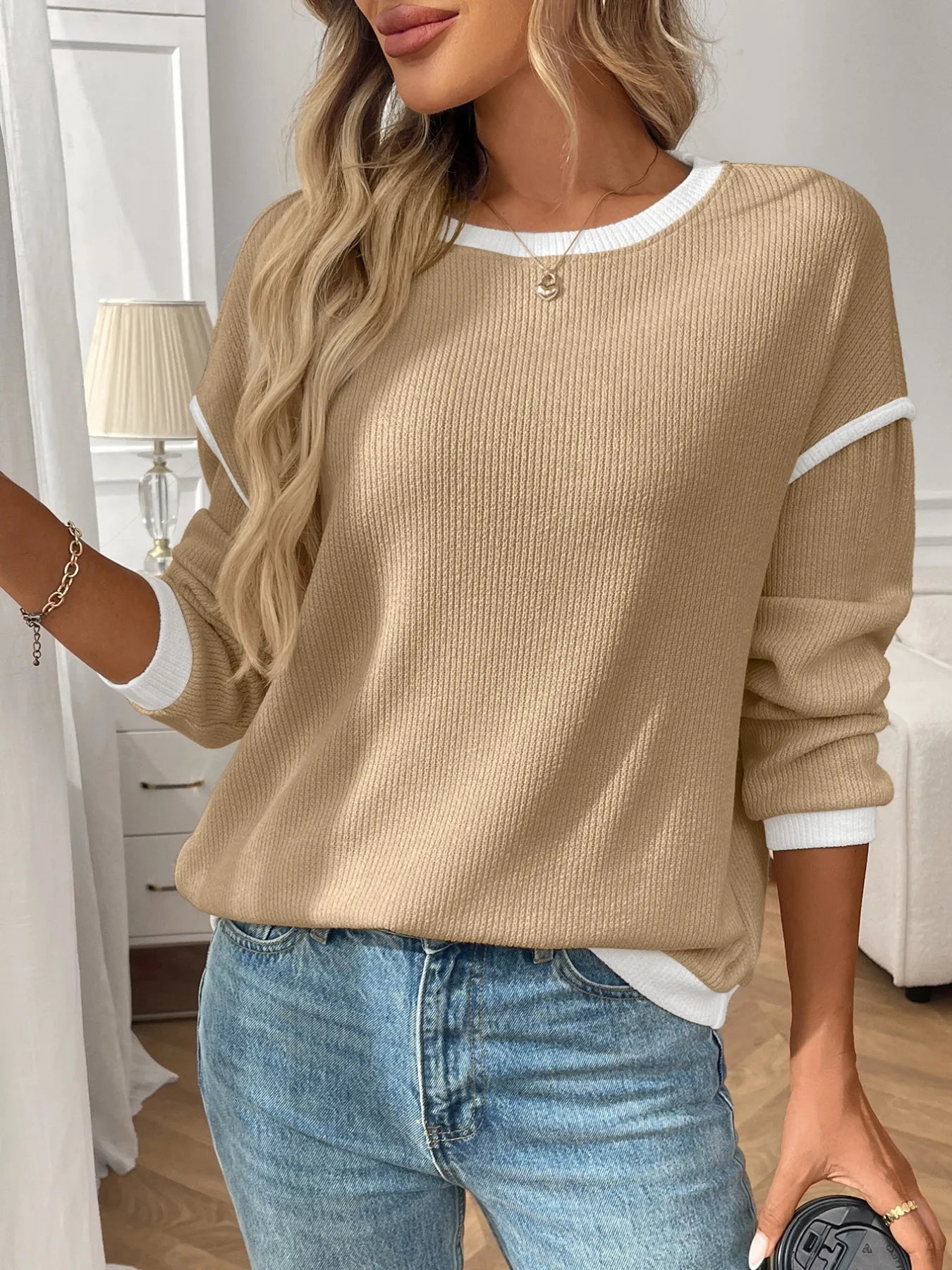 Ribbed long sleeve top with contrast trim and stretch fabric in a fitted style.