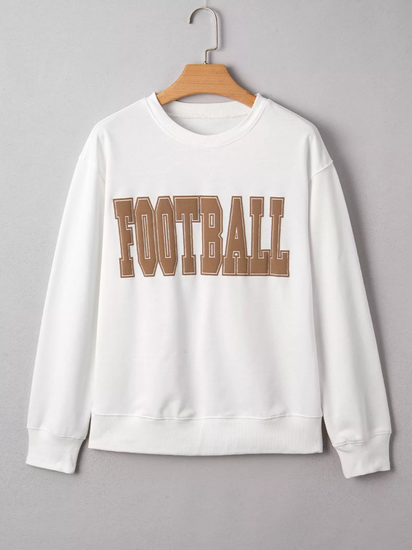 White crew neck sweatshirt with brown 3D Football graphic.