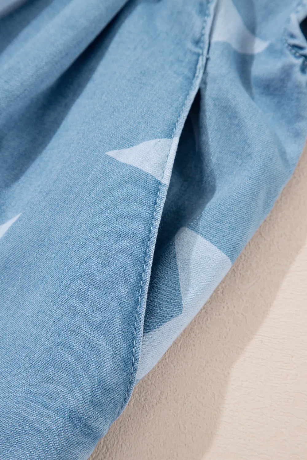 Star print denim overalls with a square neck and pockets in a cotton blend fabric.