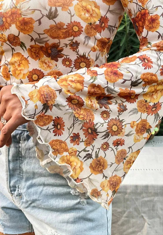 Printed mock neck top with flare sleeves in slightly stretchy polyester fabric.