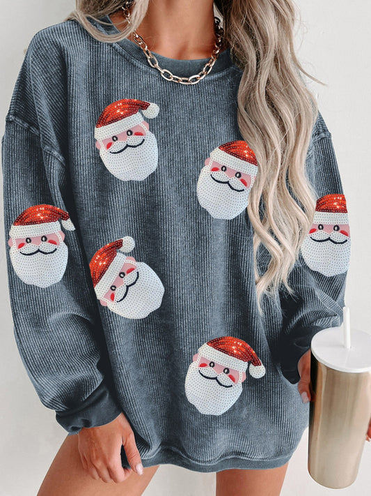 Gray ribbed sweatshirt with sequin Santa patches and long sleeves, modeled by a woman holding a tumbler.