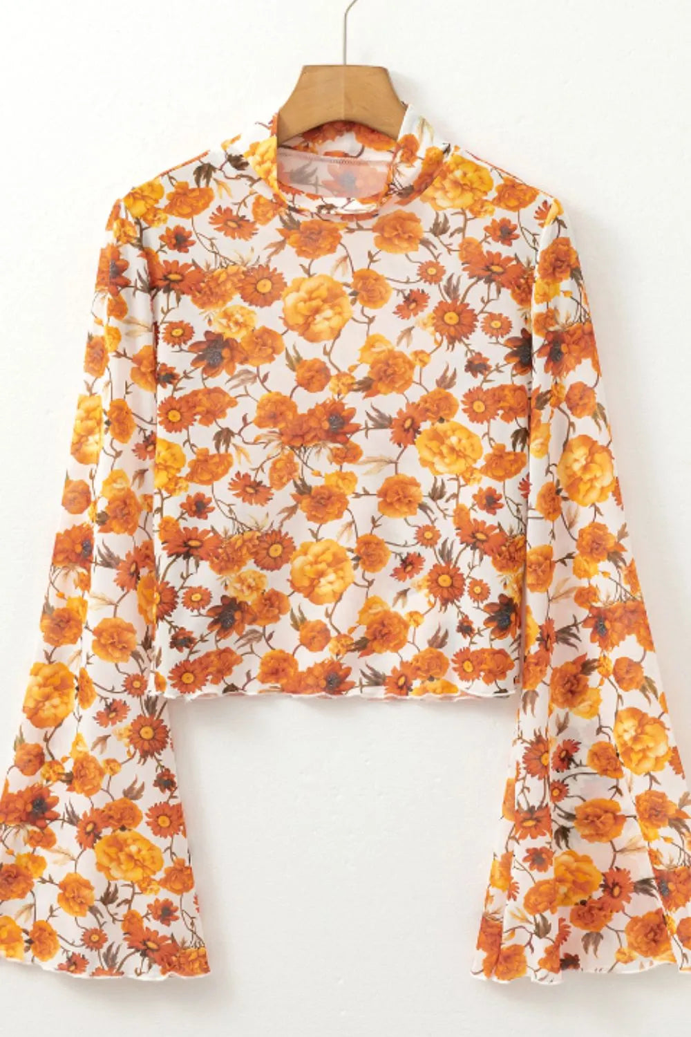 Flare sleeve mock neck top in slightly stretchy printed polyester with opaque fabric.