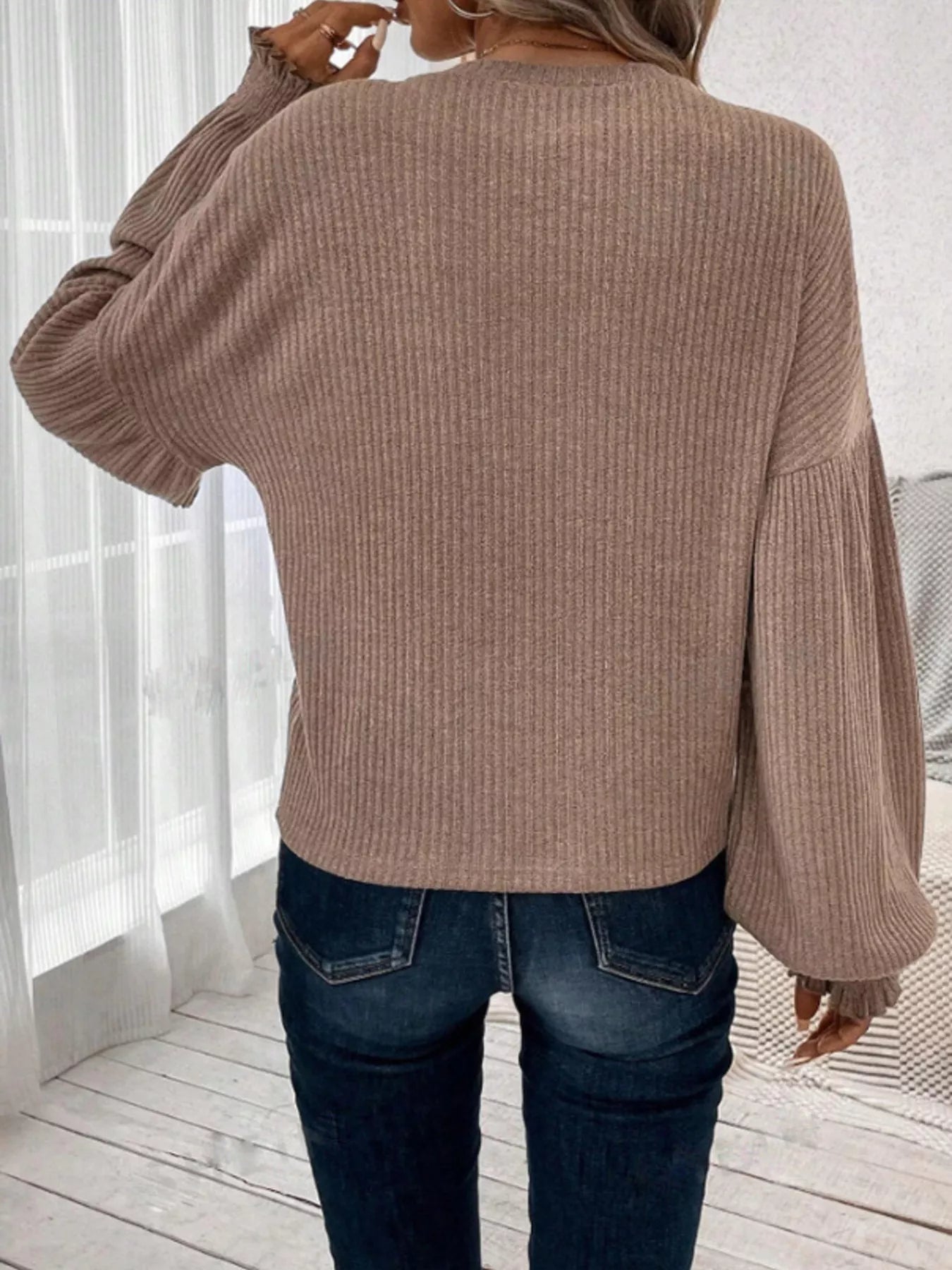Ribbed long sleeve t-shirt made of a stretchy polyester blend in various sizes.
