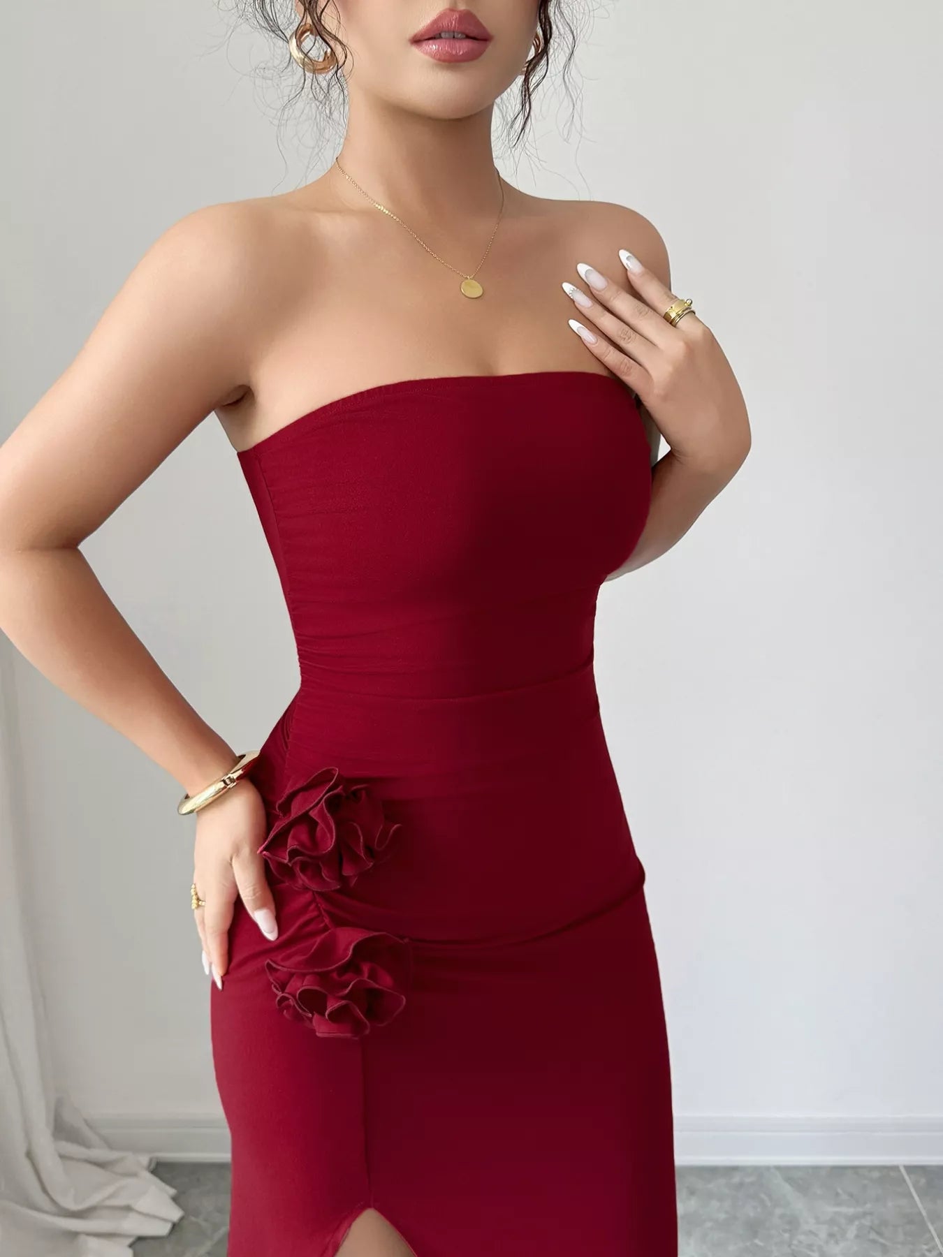 Navy blue strapless dress with front split and floral details, made from soft polyester blend.