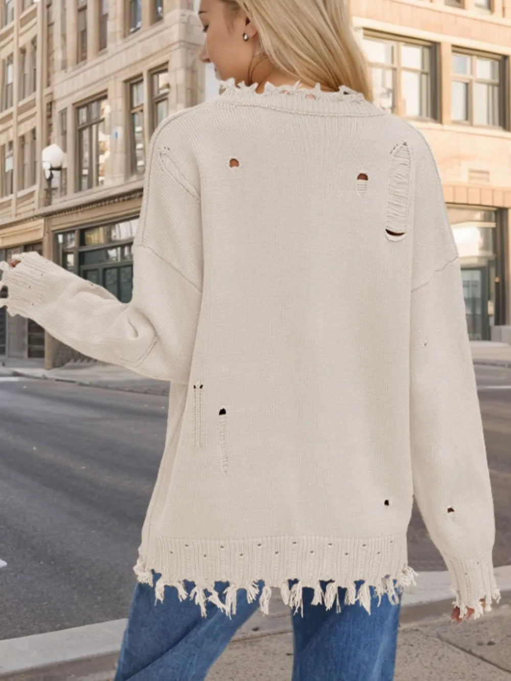 Distressed acrylic sweater featuring a US flag design, round neck, and long sleeves.