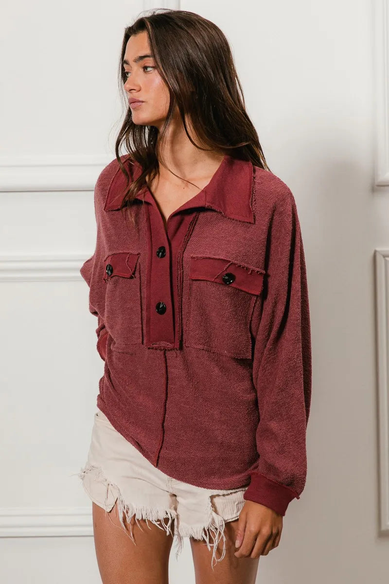 Oversized maroon French terry collared top with buttons and pockets.