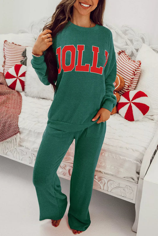 Woman wearing a green Jolly Christmas polyester top and drawstring pants set.