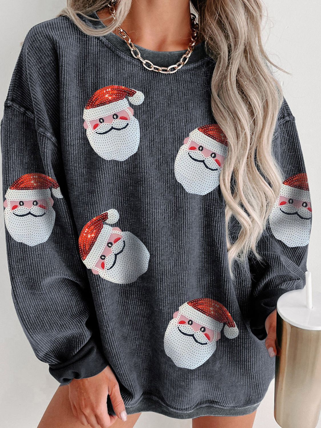 Gray ribbed sweatshirt with sequin Santa patches and long sleeves.