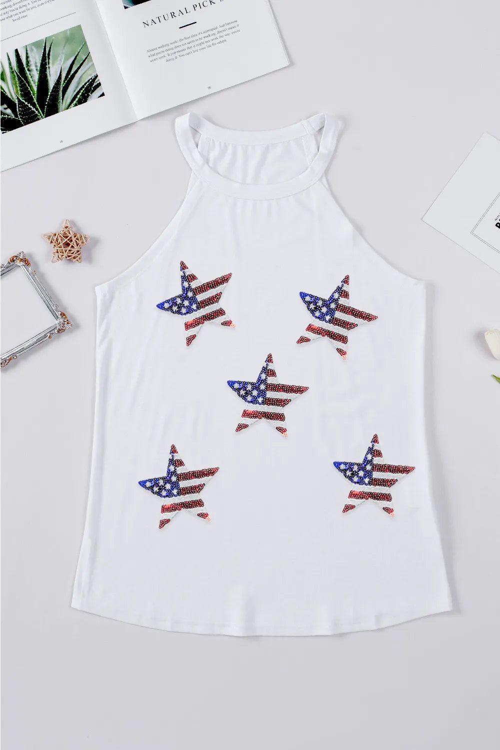 Sheer tank top with sequin US flag design and Grecian neckline in a polyester blend.