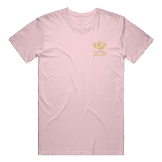 Pink Bella Canvas T-shirt with gold embroidered magnolia blossom on chest.