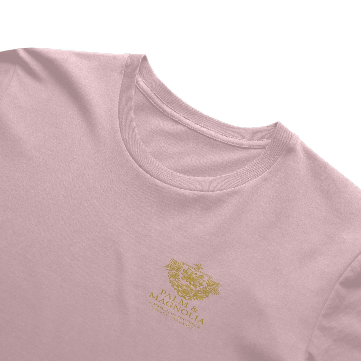 Pink Bella Canvas T-shirt with gold embroidered magnolia blossom design.
