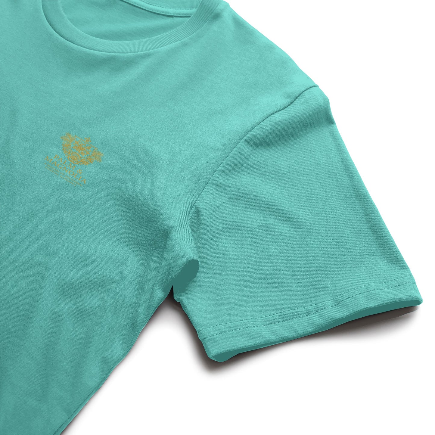 Teal Bella Canvas T-shirt with gold embroidered floral design.