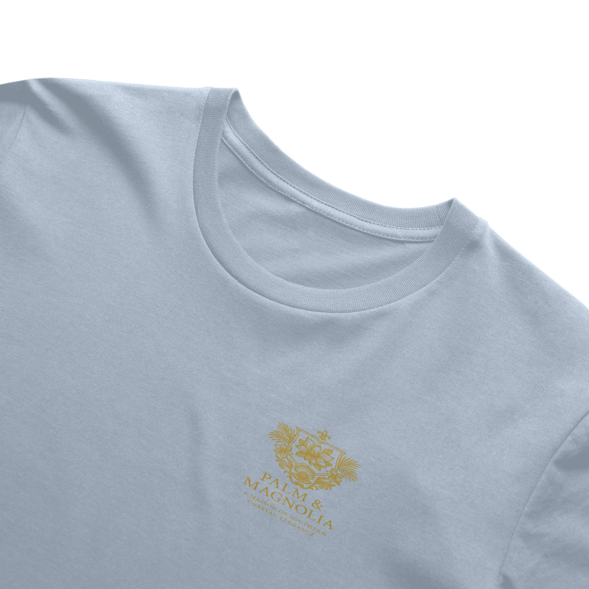 Pink Bella Canvas T-shirt with gold embroidered Magnolia Blossom on chest.