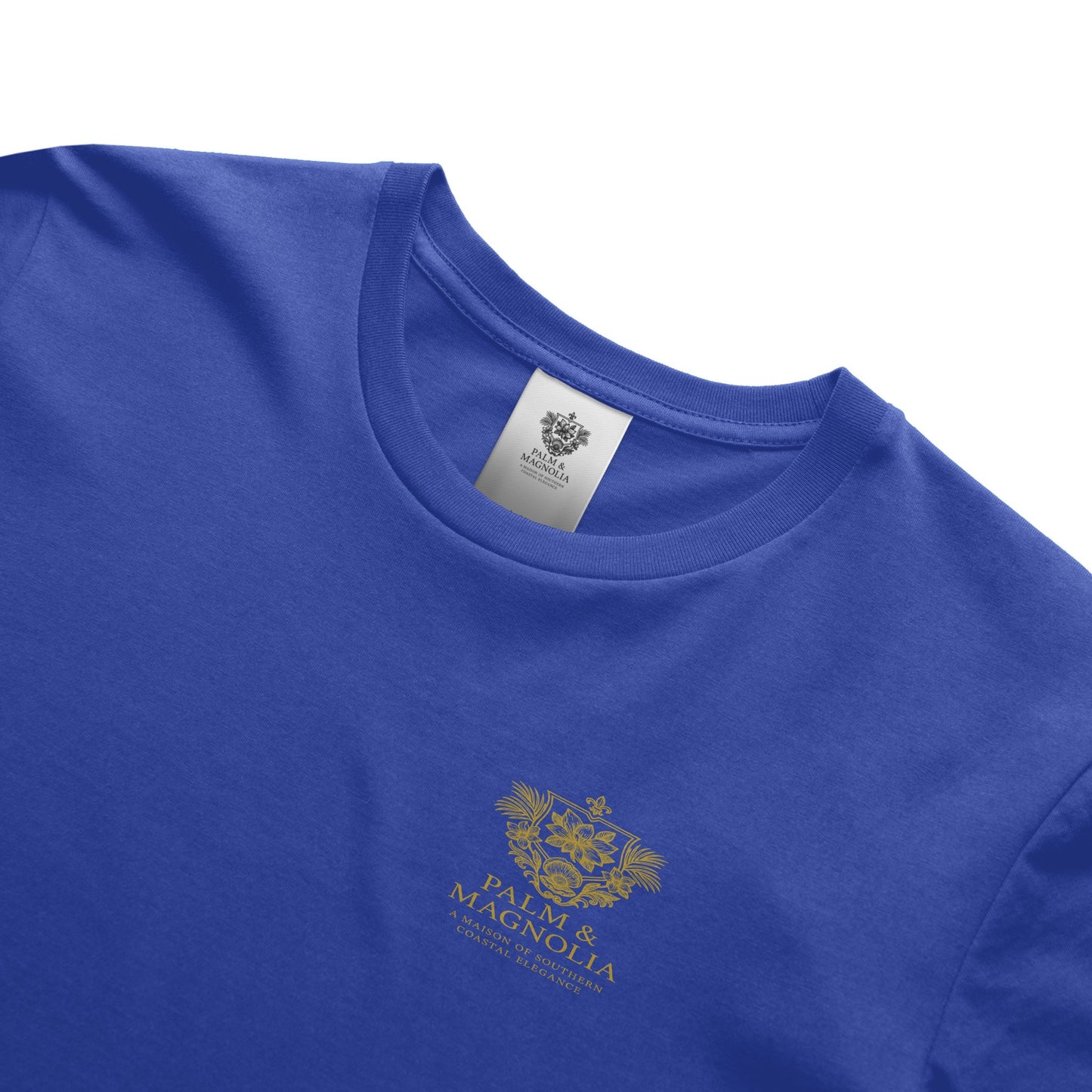 Blue unisex ring-spun cotton tee with gold Palm & Magnolia emblem on chest.