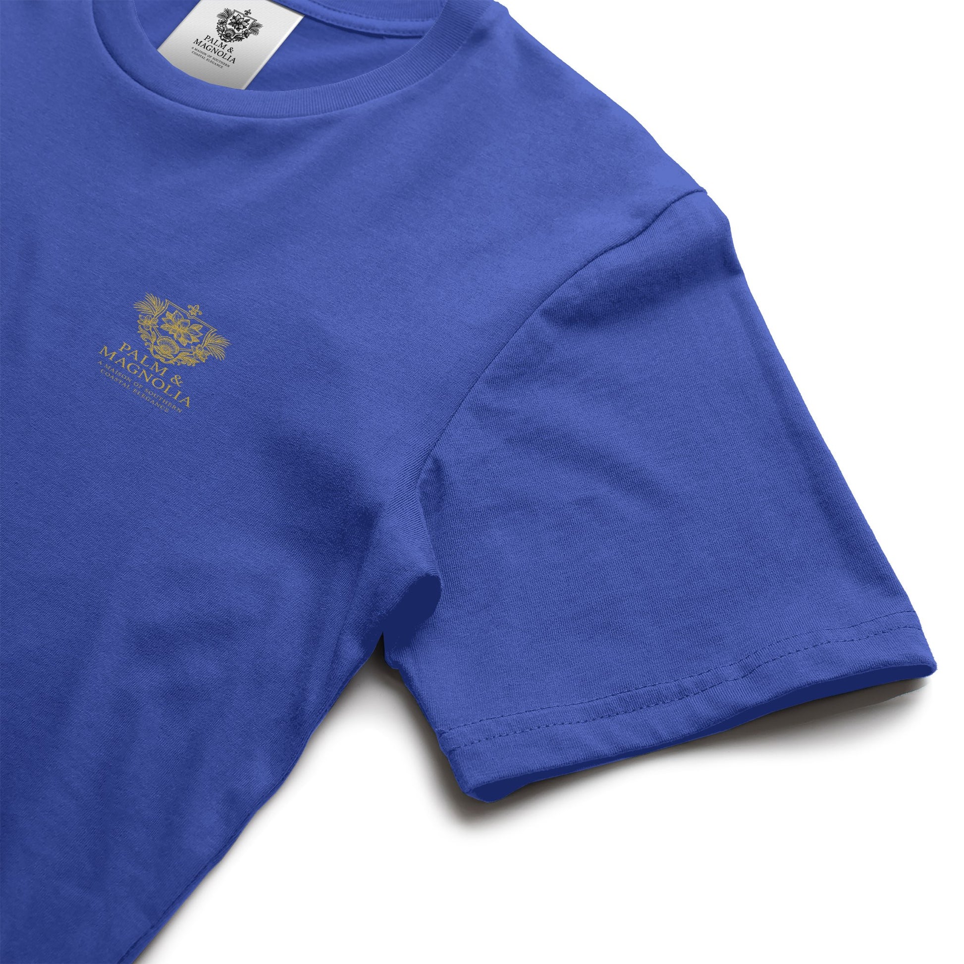 Navy blue unisex tee with gold Ocean Springs Serenity emblem on chest.