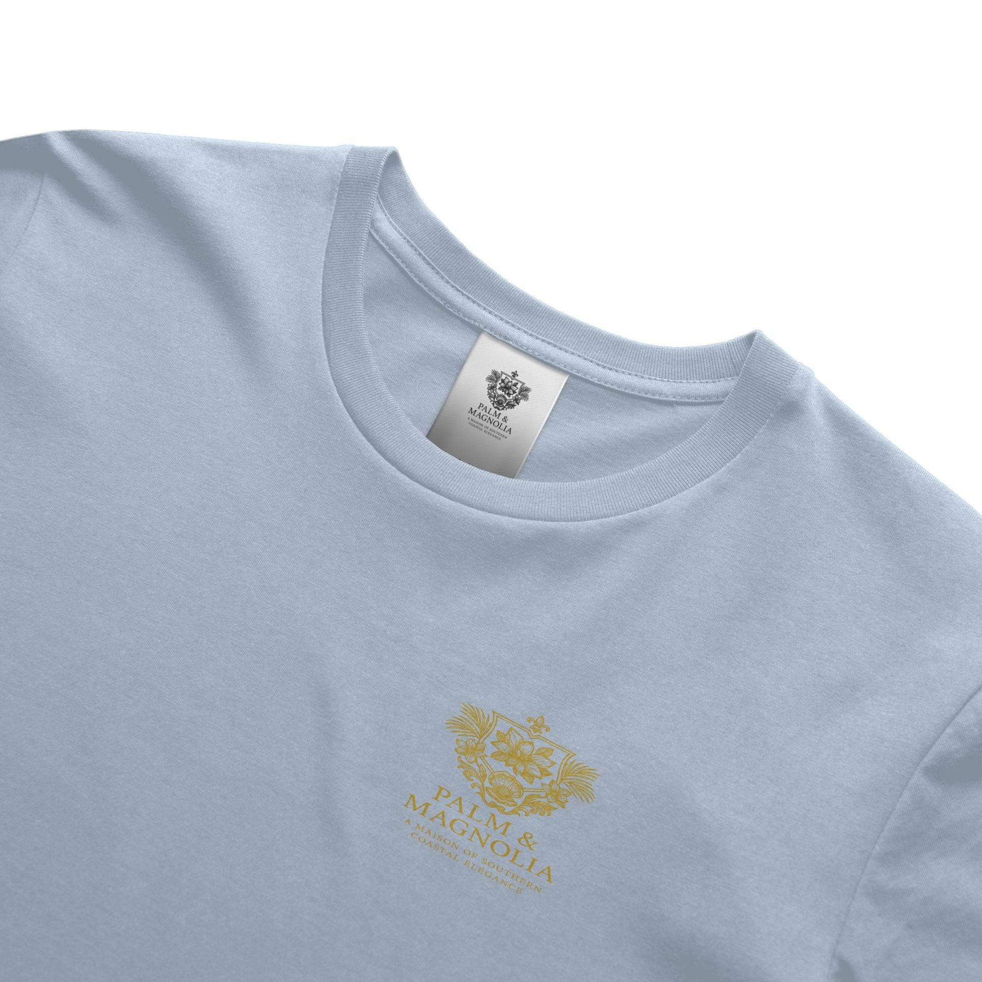 Light blue unisex tee with gold Palm & Magnolia crest on chest.