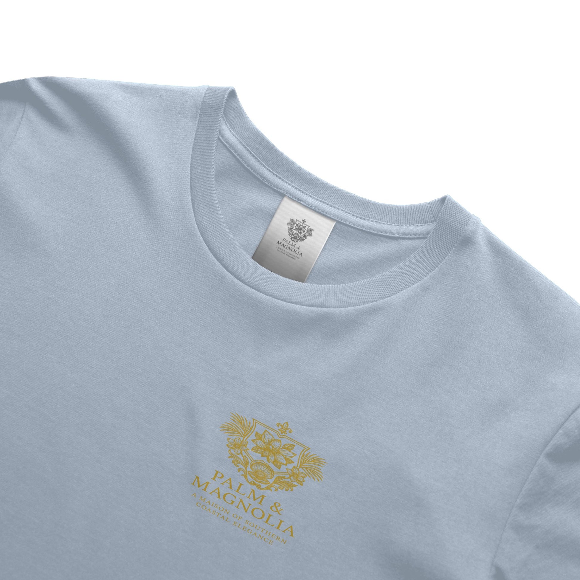 Light blue unisex ring-spun cotton tee with gold Palm & Magnolia crest.