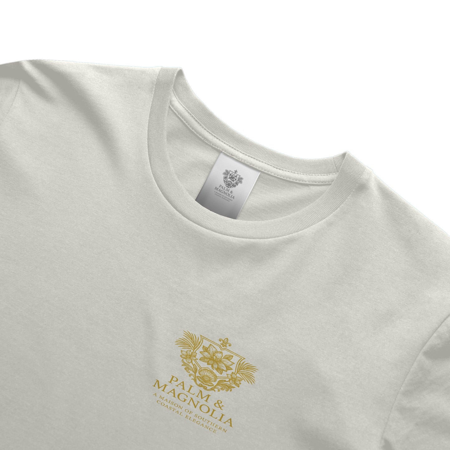 White Palm & Magnolia tee with gold crest on chest, crew neck, ring-spun cotton.