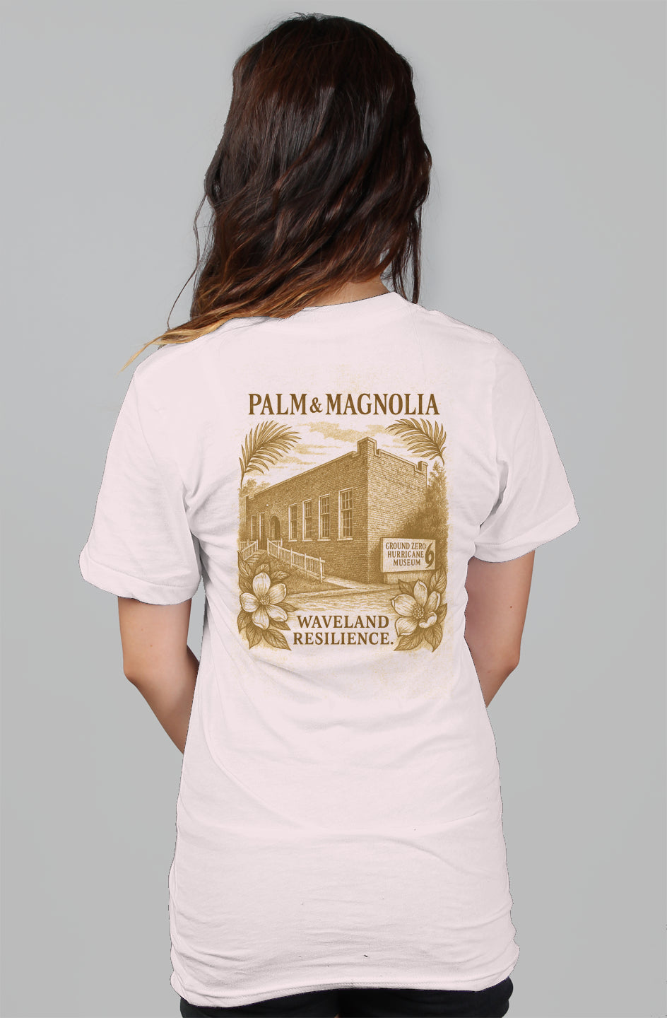 Back view of white women's relaxed tee with sepia Waveland Resilience building print.