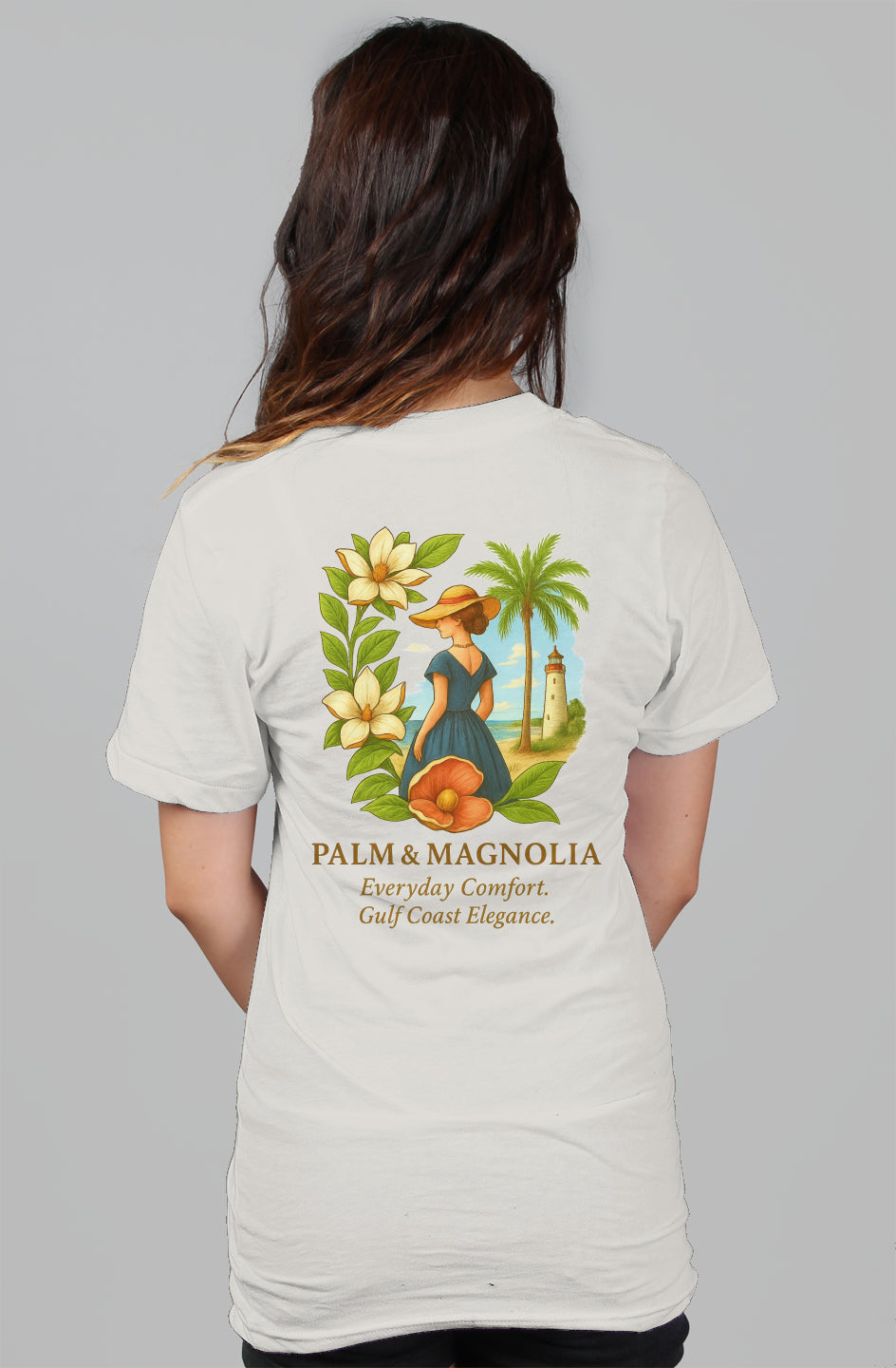 White women's relaxed cotton tee with back print of a woman in a hat, magnolias, palm tree, and lighthouse.