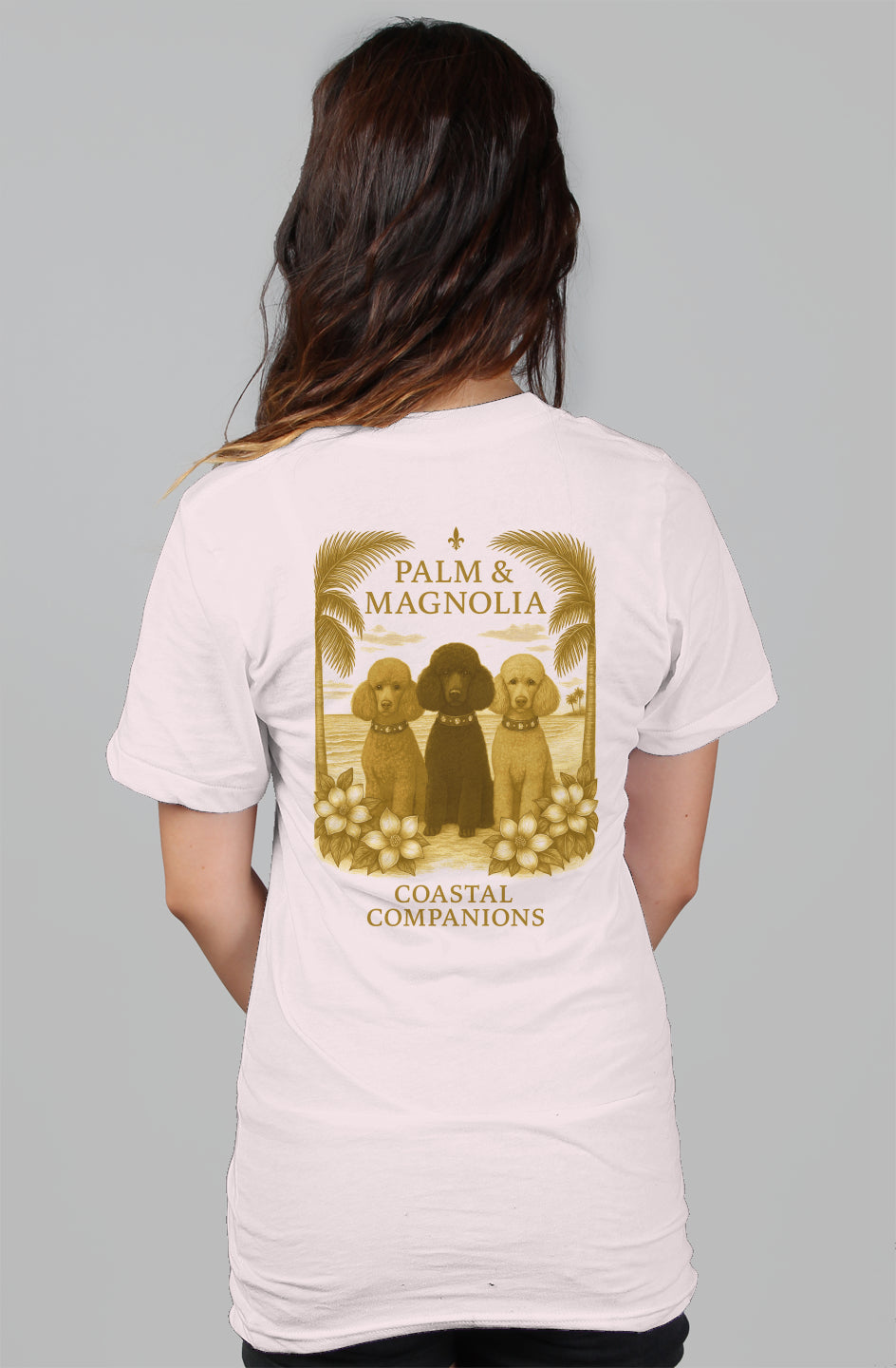 Back view of a white women's relaxed tee with three poodles framed by palms and magnolias.