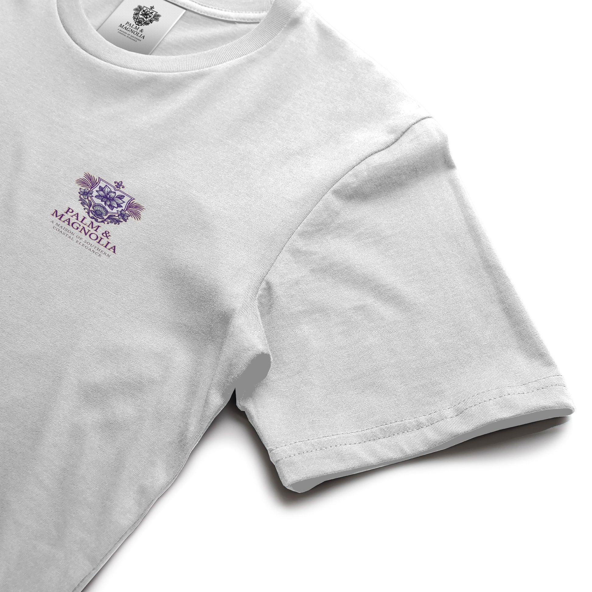 White ring-spun cotton tee with purple Palm & Magnolia poodle emblem on chest.