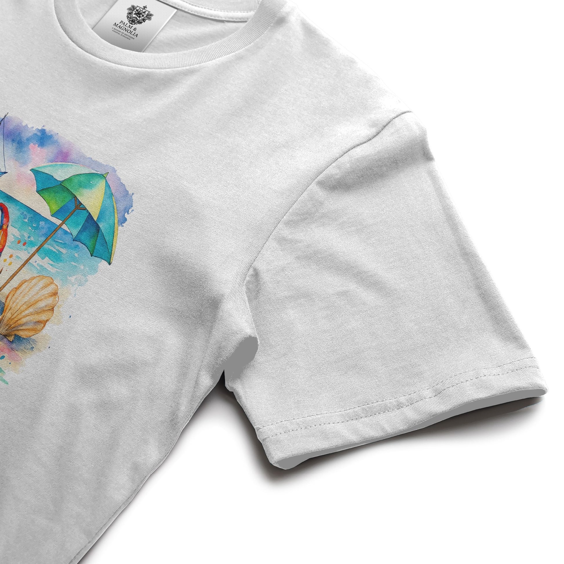 White unisex cotton t-shirt with front print of colorful beach umbrella, seashell, and sunny rays.