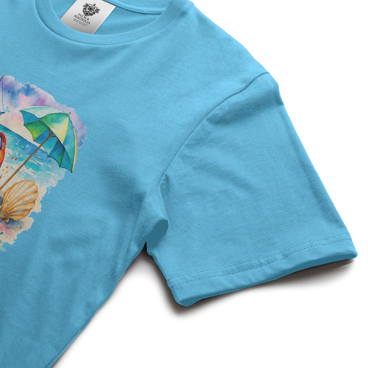Light blue unisex cotton t-shirt with front print of beach umbrella, seashell, and sunny waves.