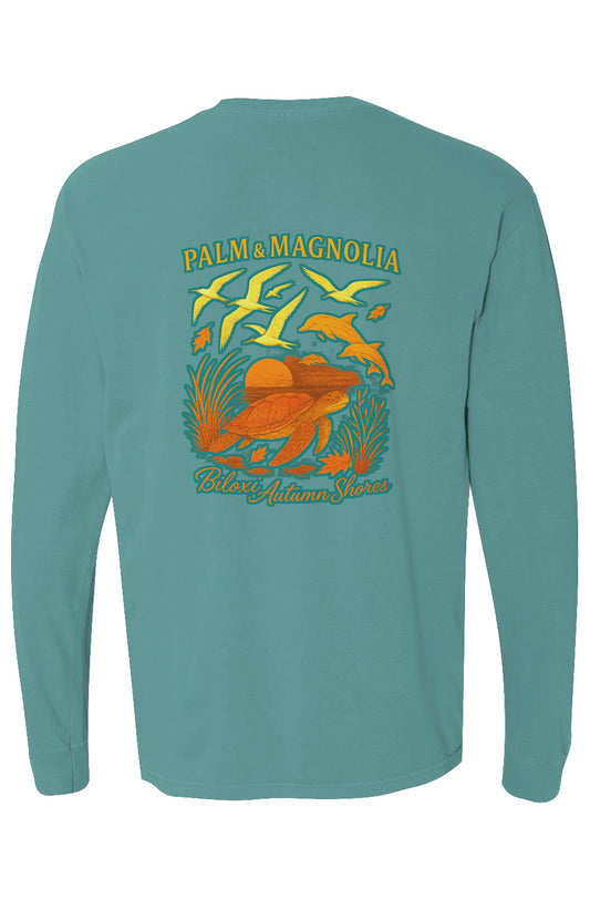 Back view of green long-sleeve tee with Palm & Magnolia Biloxi Autumn Shores print of sunset, birds, dolphin, and turtle.