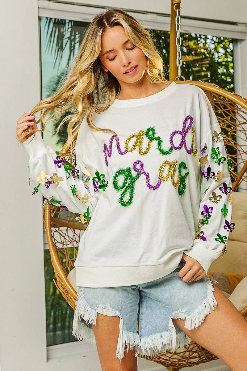 Light purple pullover with Fleur De Lis designs on sleeves and a relaxed fit for Mardi Gras wear