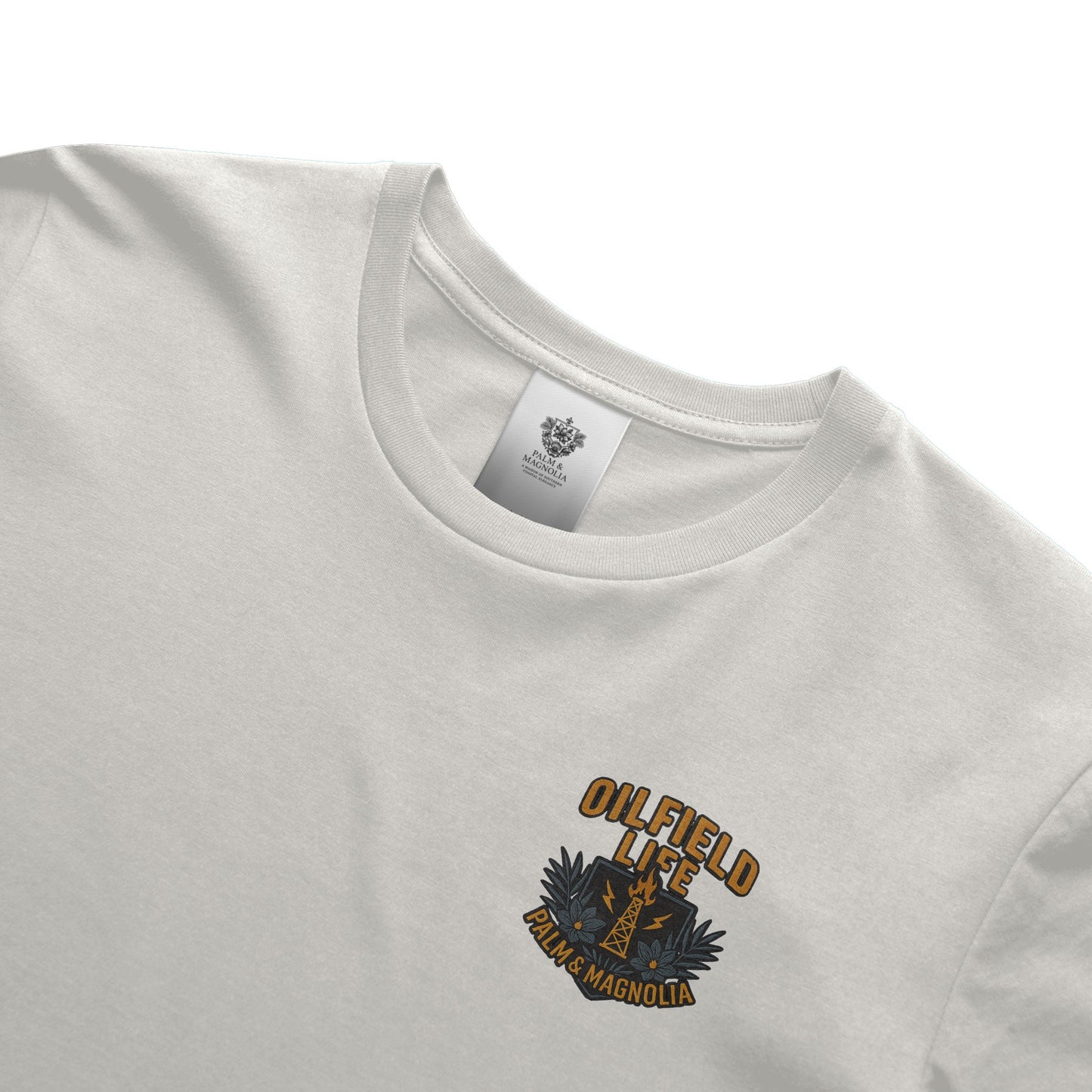 White heavyweight cotton T-shirt with orange "Oilfield Life Palm & Magnolia" embroidered logo.