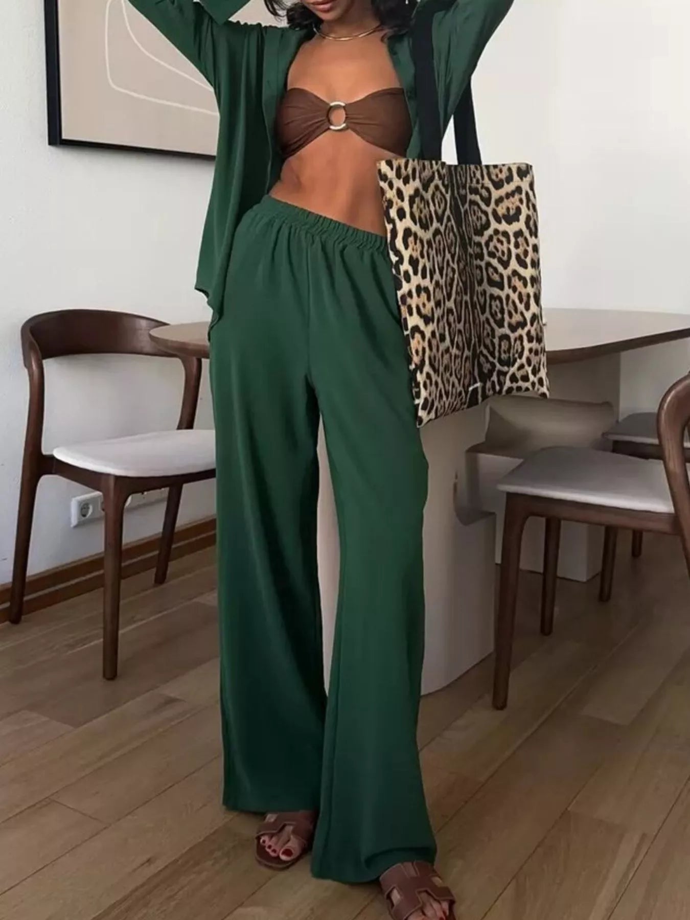 Woman modeling green two-piece button-down shirt and wide-leg pants set.