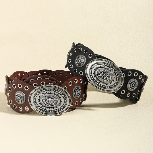 Two oval PU leather belts in brown and black with silver bohemian buckles and eyelets.