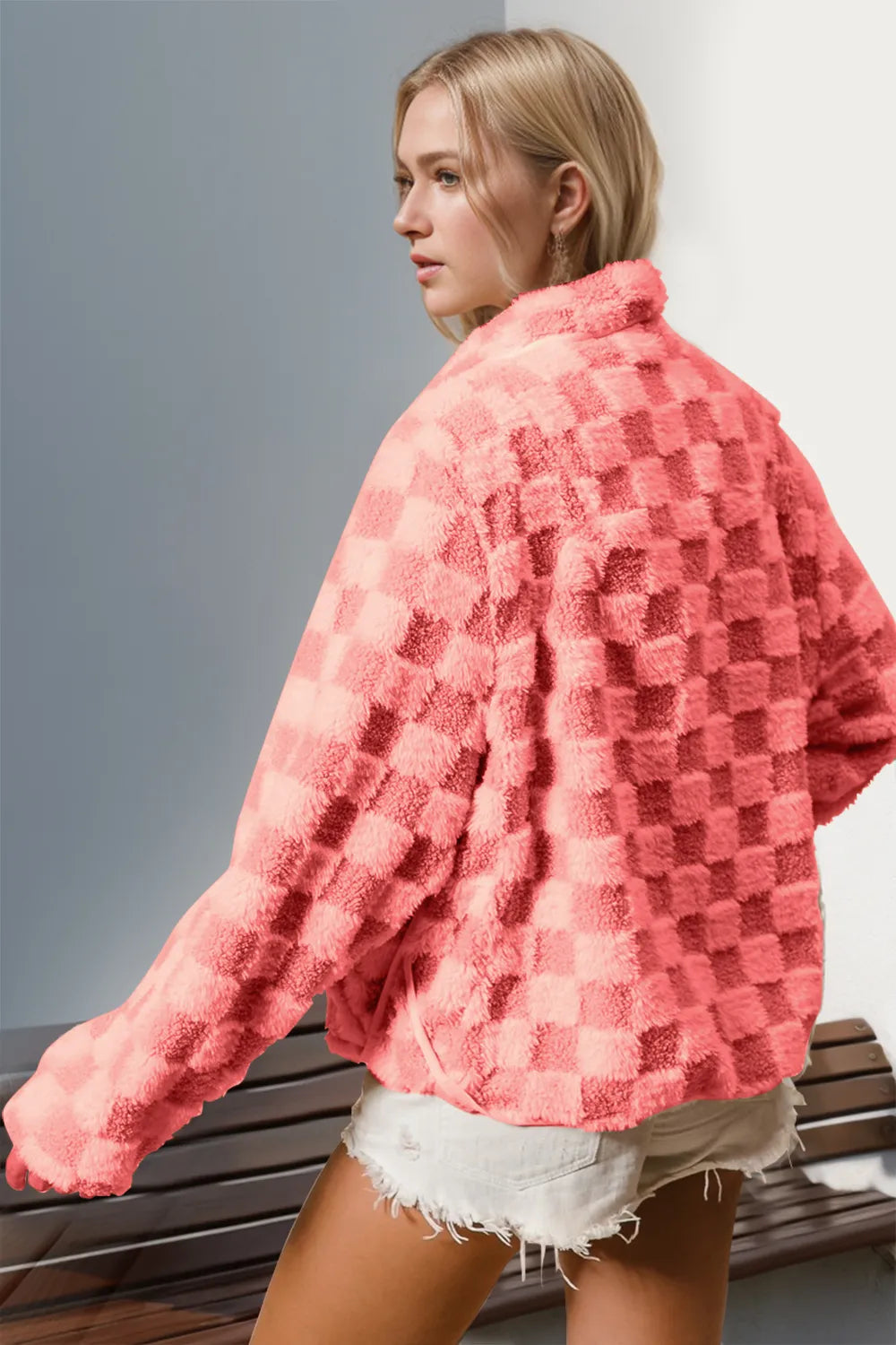 Back view of a pink checkered fuzzy long-sleeve jacket on a model.