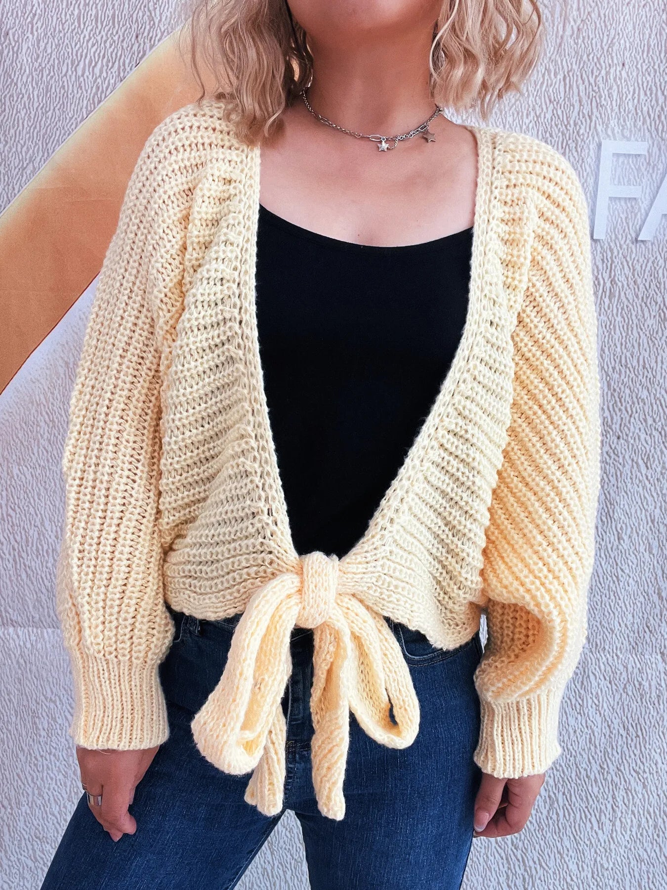 Light blue tie-front long sleeve cardigan with slight stretch, model wearing.