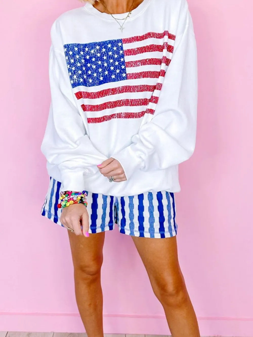 Cotton blend long sleeve sweatshirt with US flag design and round neck.