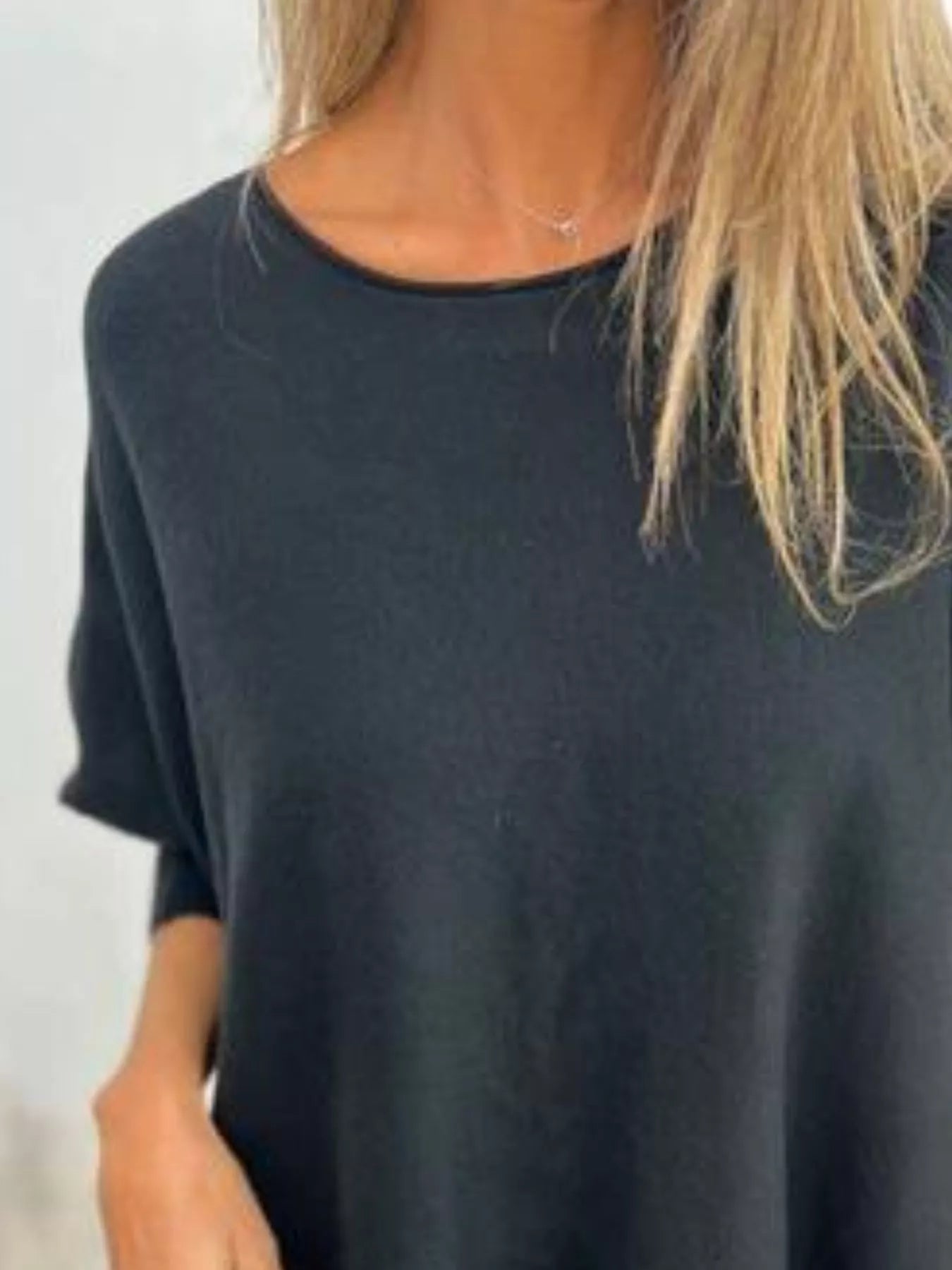 Plus size round neck long sleeve knit top in soft fabric with lace trim detail.